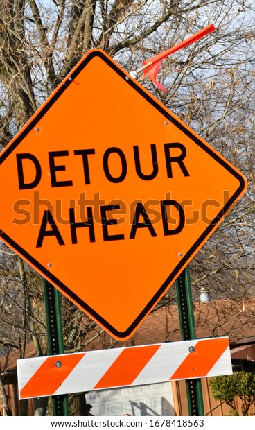 Orange road\
closed ahead sign on a city\
street