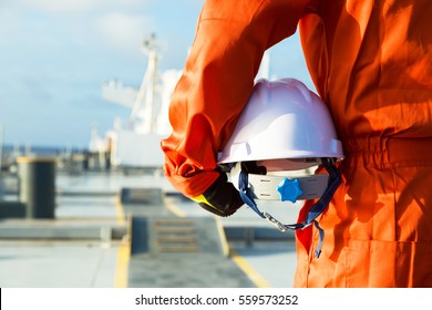 Orange Robe Engineer With Helmet On The Deck Of Oil Tanker.