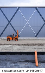 Orange roller machine on the contruction site