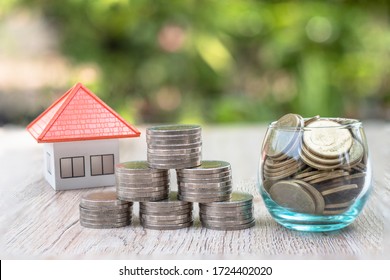 The orange roof house near the coin in a glass bottle Ideas to save money, buy a house and mortgage, real estate and invest, buy a house, rental tax, sales.