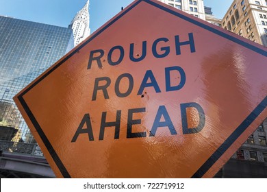 Orange Rough Road Ahead Sign