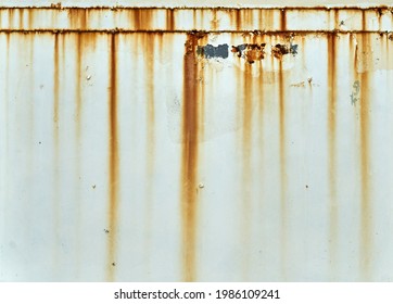 Orange Rust Streaks Down A White Wall