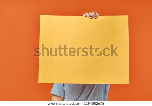 Download Orange Sheet Paper Hand Mockup Poster Stock Photo Edit Now 1194082675 PSD Mockup Templates