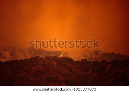 Orange sky over the mountains of California. Fires near Los Angeles. Smoke pollution in US air