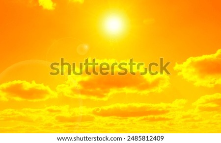 Orange sky with sun and clouds during hot summer weather