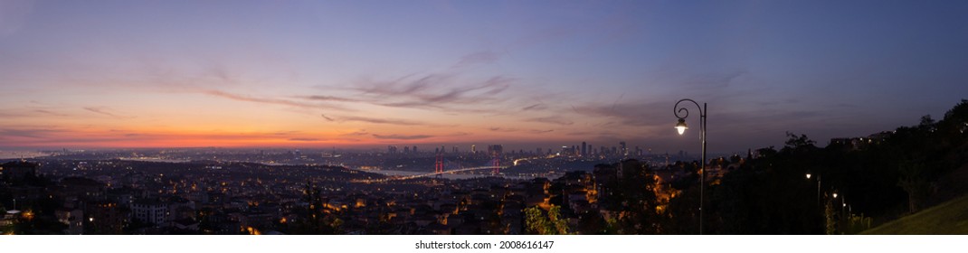 Orange sky at sunset in the evening. Silhouette and outlines of the buildings. Evening views of buildings and streets of the city of Istanbul.