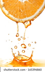 Orange Slice And Splash Of Juice Isolated On White