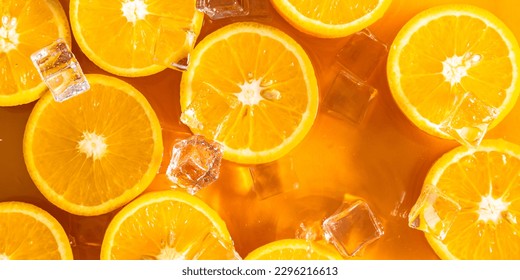 Orange slices and ice cubes with sparkling juice, fresh fruit lemonade with sparkling water and ice cubes, summer lemonade orange drink. Flat lay, top view - Shutterstock ID 2296216613