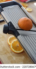 Orange Slices From Mandolin And On Butcher Block Cutting Board