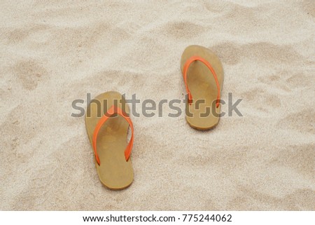 Orange Slipper (Sandals) on the sandy tropical beach, Summer Holiday in Thailand and Vacation Concept.