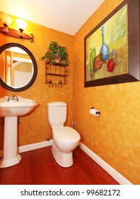 Orange Small Bathroom With Large Painting.