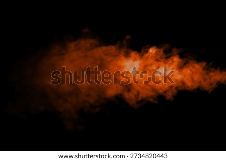 Orange smoke effect floating on black background. Abstract bright and intense background. Fog or smoke.