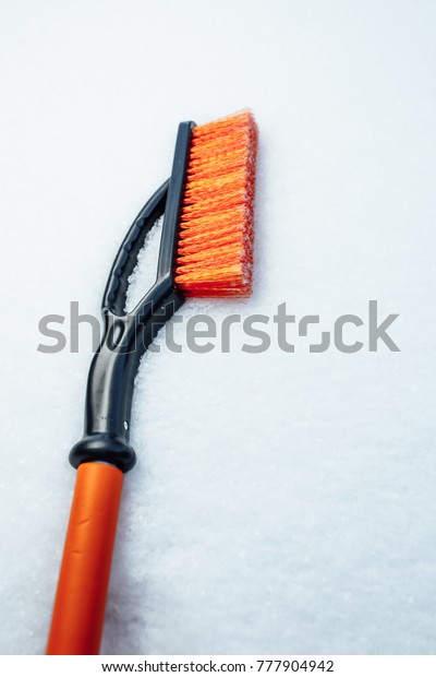 orange snow\
brush for car, snowflakes\
background