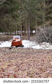 Orange Snowmobile Abandoned In The Forest, Late Winter Canada