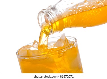 Orange Soda Pouring Into Glass On White Background