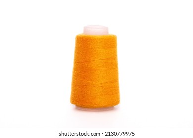 Orange spool of thread isolated on white background. Skein of woolen threads. Yarn for knitting. Materials for sewing machine. Coil.