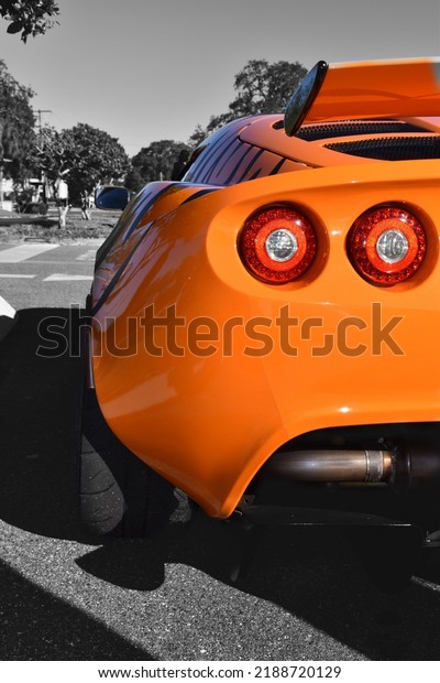 Orange sport car showcasing\
its rear