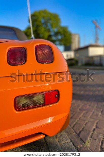 orange\
sports car convirtable parked in amsterdam\
summer
