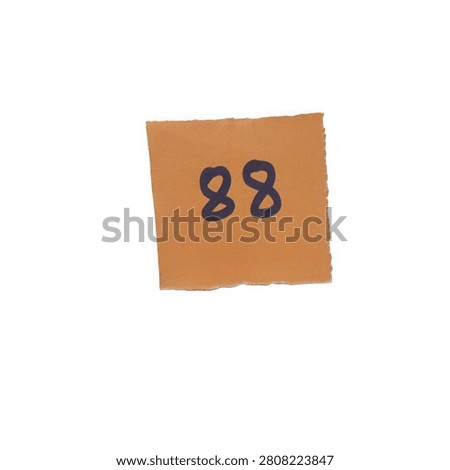 Orange square paper note with the number eighty eight written in black marker