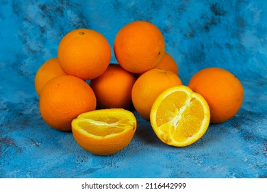 Orange Stack On Textured Blue Background, Side Or Profile View Of Lots Of Fresh Oranges. No People, Fruitarianism.