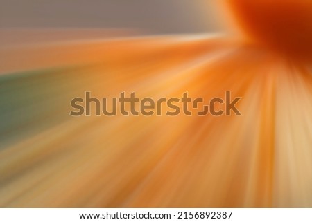 An orange starburst with dynamic sparkles with motion blur
