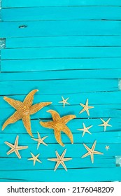 Orange Starfish On Blue Wooden Boards. Vacation, Travel Concept. Copy Space