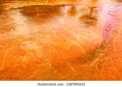 An Orange Stream Of Wastewater Flows Into The River. Wastewater Abstract Background.