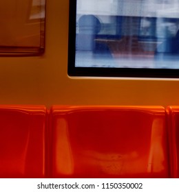 Orange Subway Train Plastic Chairs And Part Of Metro Train Window Glass