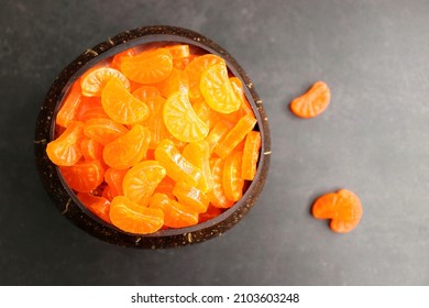 Orange sugar candy. Indian Vintage style boiled sugar confectionery Orange flavored candy or chocolate. Old school nostalgia snacks of 90s kids. Served in a brass container with papercrafts. copyspace