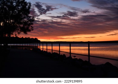 orange sunrise and cloud reflections - Shutterstock ID 2229139895
