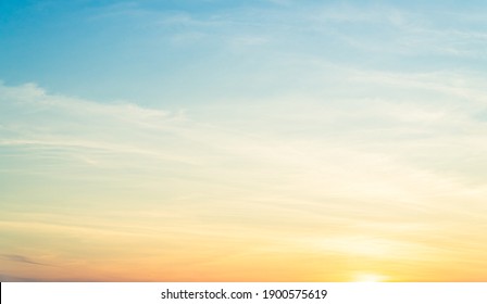Orange Sunrise Sky Background in the Morning with colorful sunset cloud And beautiful Yellow Sunny - Shutterstock ID 1900575619