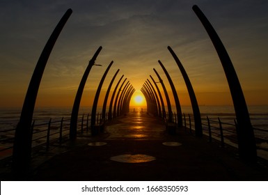 Orange sunrise through the famous Whalebone Pier in Umhlanga - Shutterstock ID 1668350593
