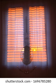 Orange sunset behind the window.