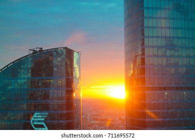 Orange sunset between buildings in Moscow's financial district, Russia.