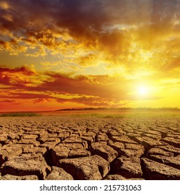 Orange Sunset In Cloudy Sky Over Desert