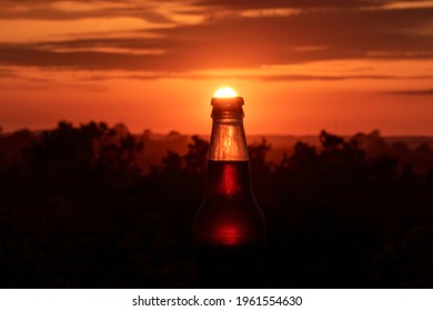 Orange sunset falling into a glass bottle