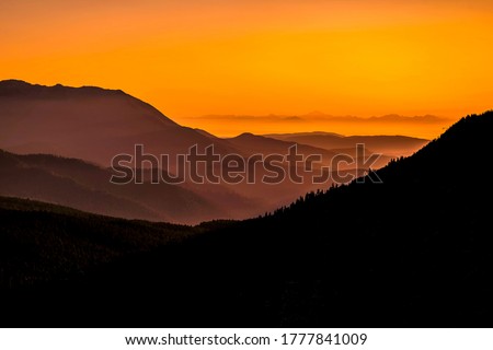 Orange sunset in mountain landscape