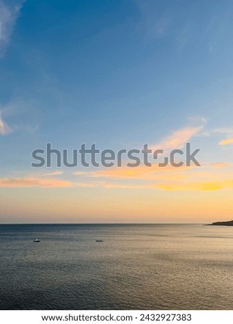 Orange sunset at the ocean, rocky ocean bay