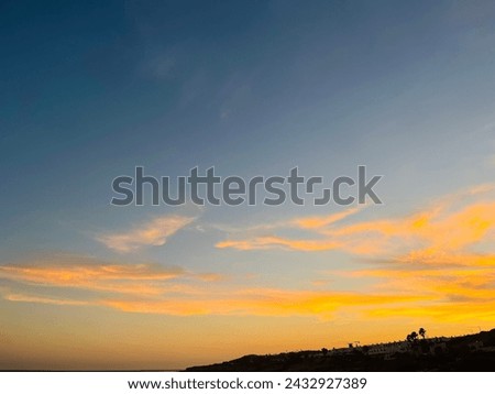 Orange sunset at the ocean, rocky ocean bay