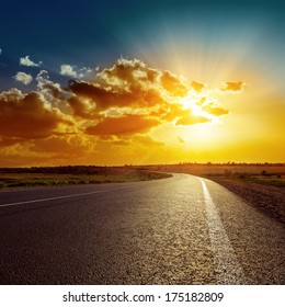 Orange Sunset Over Asphalt Road