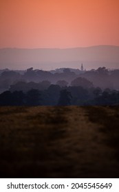 Orange sunset over the fields. Good lighting conditions, distant planes visible