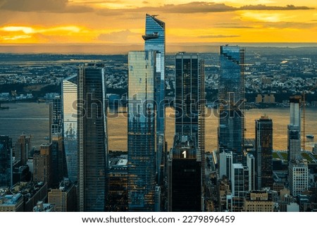 An orange sunset over the Hudson Yards in New York City.