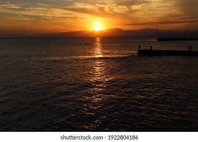 The orange sunset over the Izu Peninsula and the silhouette of the embankment seen from the Katase-Enoshima coast