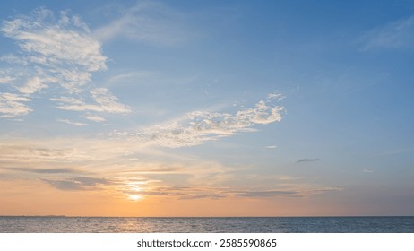 Orange sunset sky clouds over sea in the evening with yellow sunlight, Horizon sea blue sky landscape background and sun down in golden hour summer season, Dusk sky