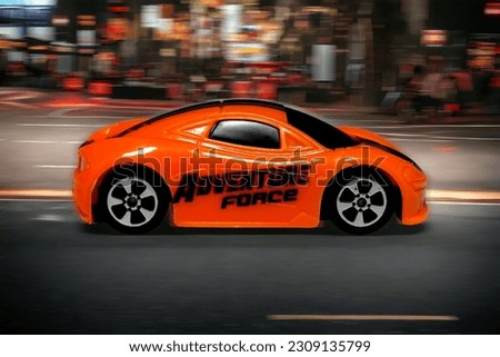 Orange super luxury car running at speed
