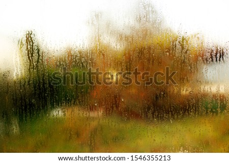 Orange tectured glass surface. Structure of water drop tracks on glazing plastic (pvc) window. Grunge pattern for texture background. Condensation drip due to bad ventilation inside house. 