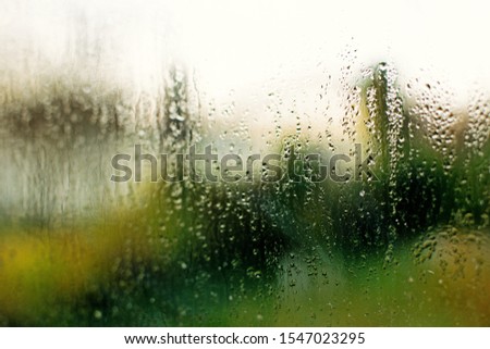 Orange tectured glass surface. Structure of water drop tracks on glazing plastic (pvc) window. Grunge pattern for texture background. Condensation drip due to bad ventilation inside house. 