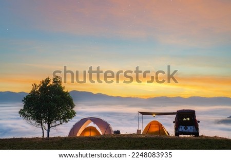 Orange tent in camping area in top of Mea Omgi at Tak, North of Thailand in winter season and balloon, Laandscape view point in travel point near Chiang mai, Thailand