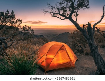 Orange tent on top of a hill at sunset - Powered by Shutterstock