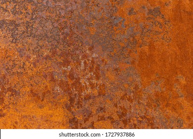 Orange textured old rusty metal surface. An weathered oxidized patina with a copper color, texture and structure. Vintage material effect